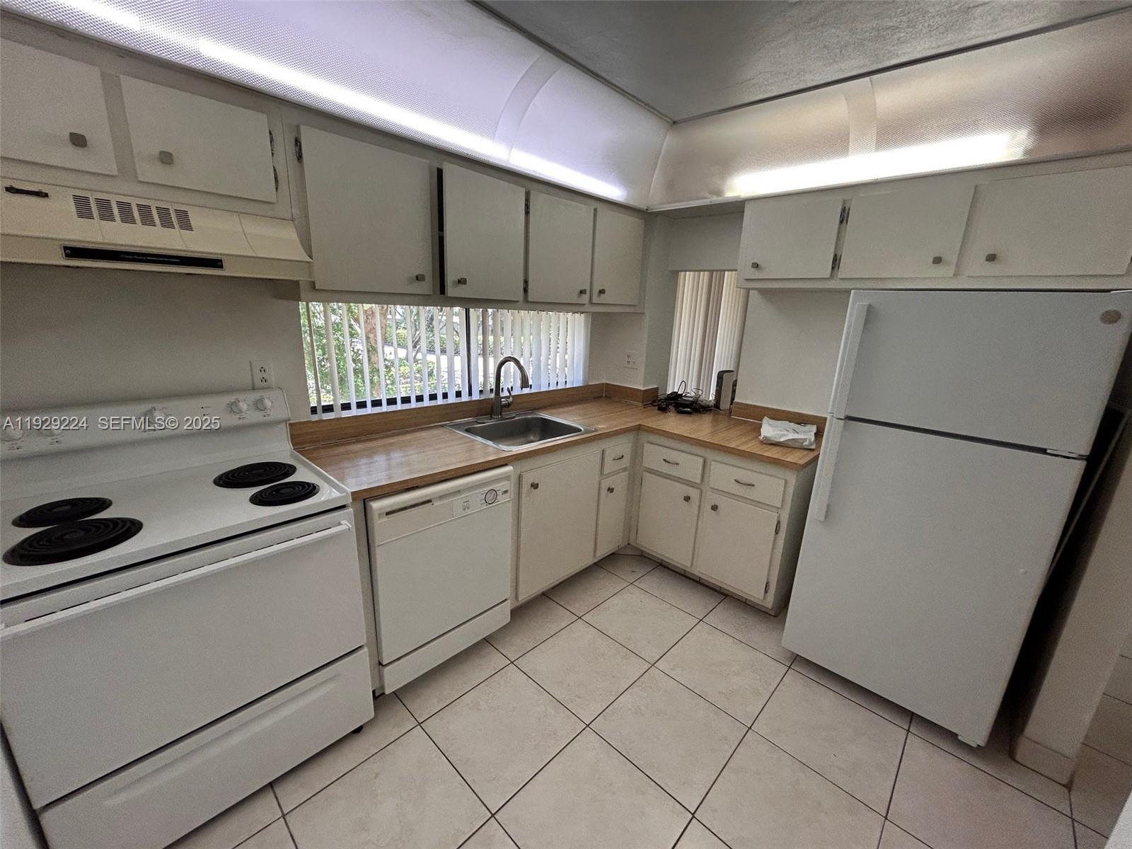 16919 North Bay Road, Unit 214 Sunny Isles Beach, FL 33160 - Photo 30 of 42 a kitchen with a sink cabinets and appliances