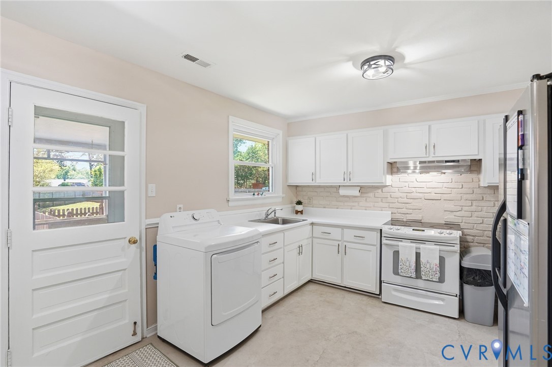 2403 Omega Road Henrico, VA 23228 - Photo 10 of 39 a kitchen with white cabinets and white appliances