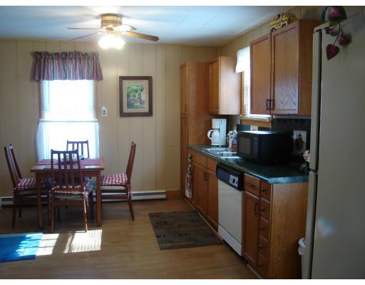 29 Carew Terrace Springfield, MA 01104 - Photo 4 of 11 a kitchen with a dining table chairs and a refrigerator