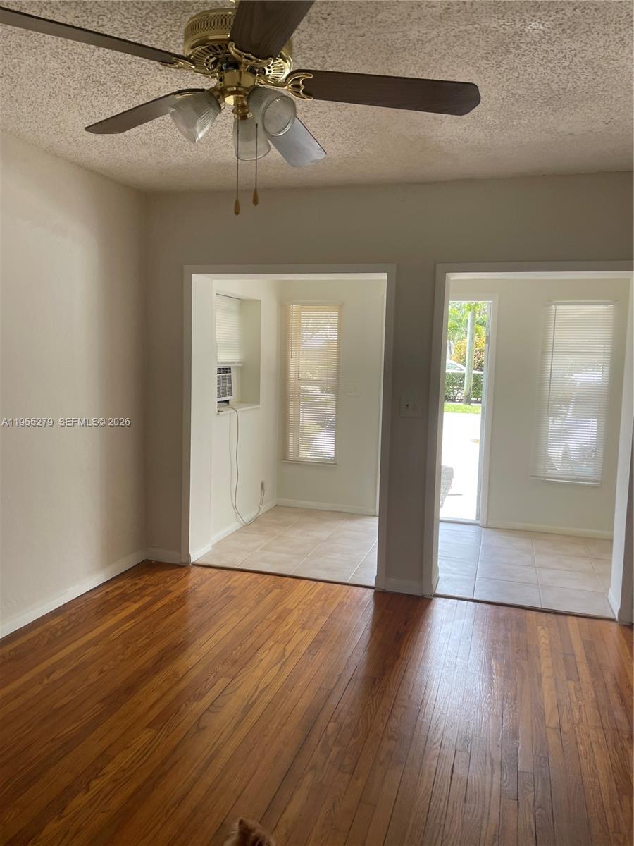 1913 Harding Street Hollywood, FL 33020 - Photo 1 of 9 a view of an empty room with wooden floor and a window