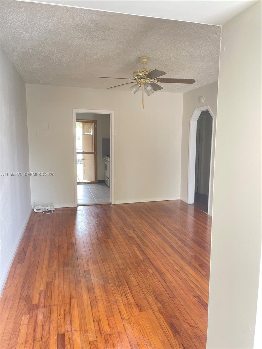 1913 Harding Street Hollywood, FL 33020 - Photo 2 of 9 a view of a room with wooden floor and white walls
