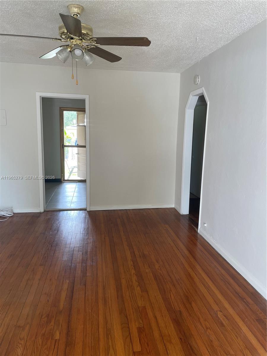 1913 Harding Street Hollywood, FL 33020 - Photo 3 of 9 wooden floor in an empty room with a window