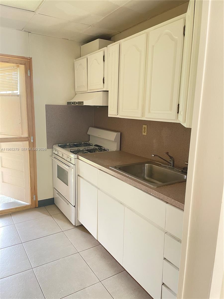 1913 Harding Street Hollywood, FL 33020 - Photo 6 of 9 a kitchen with a cabinets and white appliances