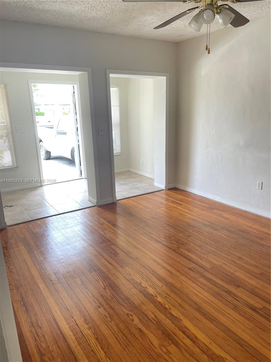 1913 Harding Street Hollywood, FL 33020 - Photo 7 of 9 an empty room with wooden floor and windows