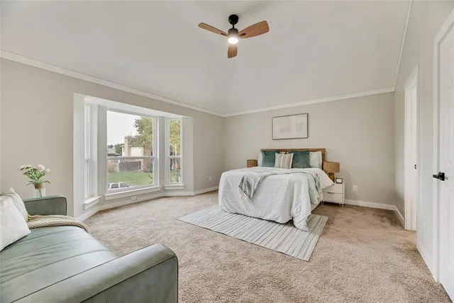 a bedroom with a large bed couch and a window