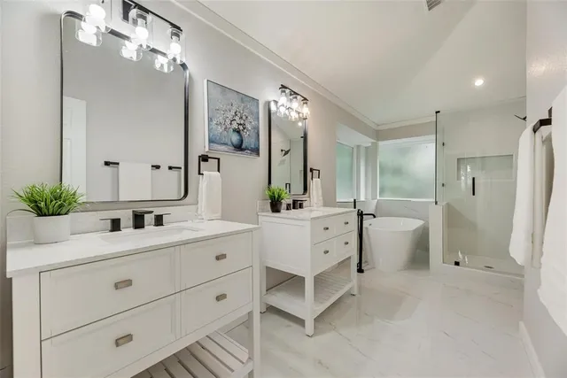 a bathroom with a double vanity sink mirror double and shower