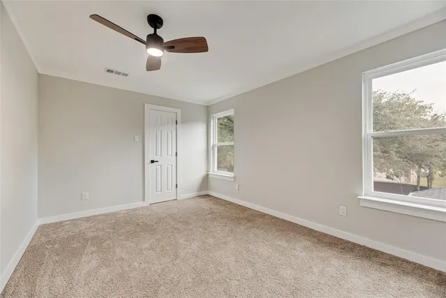 a view of room with a ceiling fan