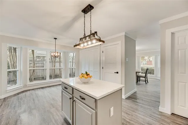 a view of a room with wooden floor and windows