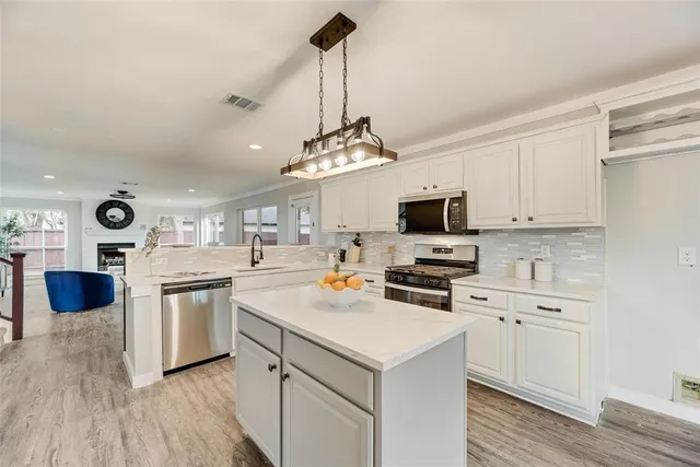a kitchen with a stove and a refrigerator