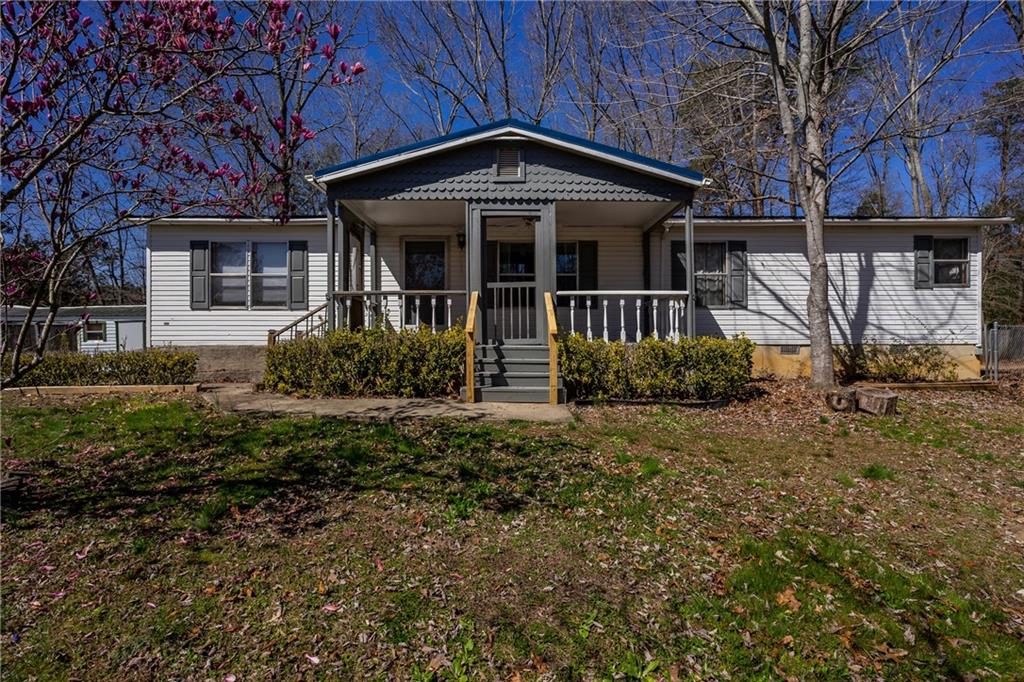 58 Holly Ridge Ellijay, GA 30540 - Photo 1 of 1 a front view of a house with garden