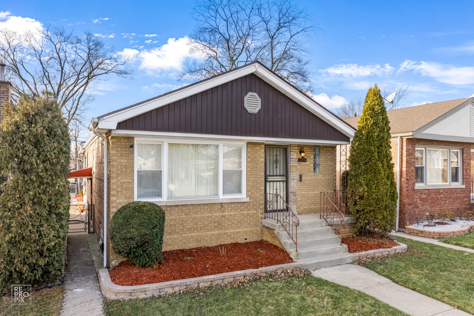 12552 South Harvard Avenue Chicago, IL 60628 - Photo 2 of 9 a front view of a house with garden