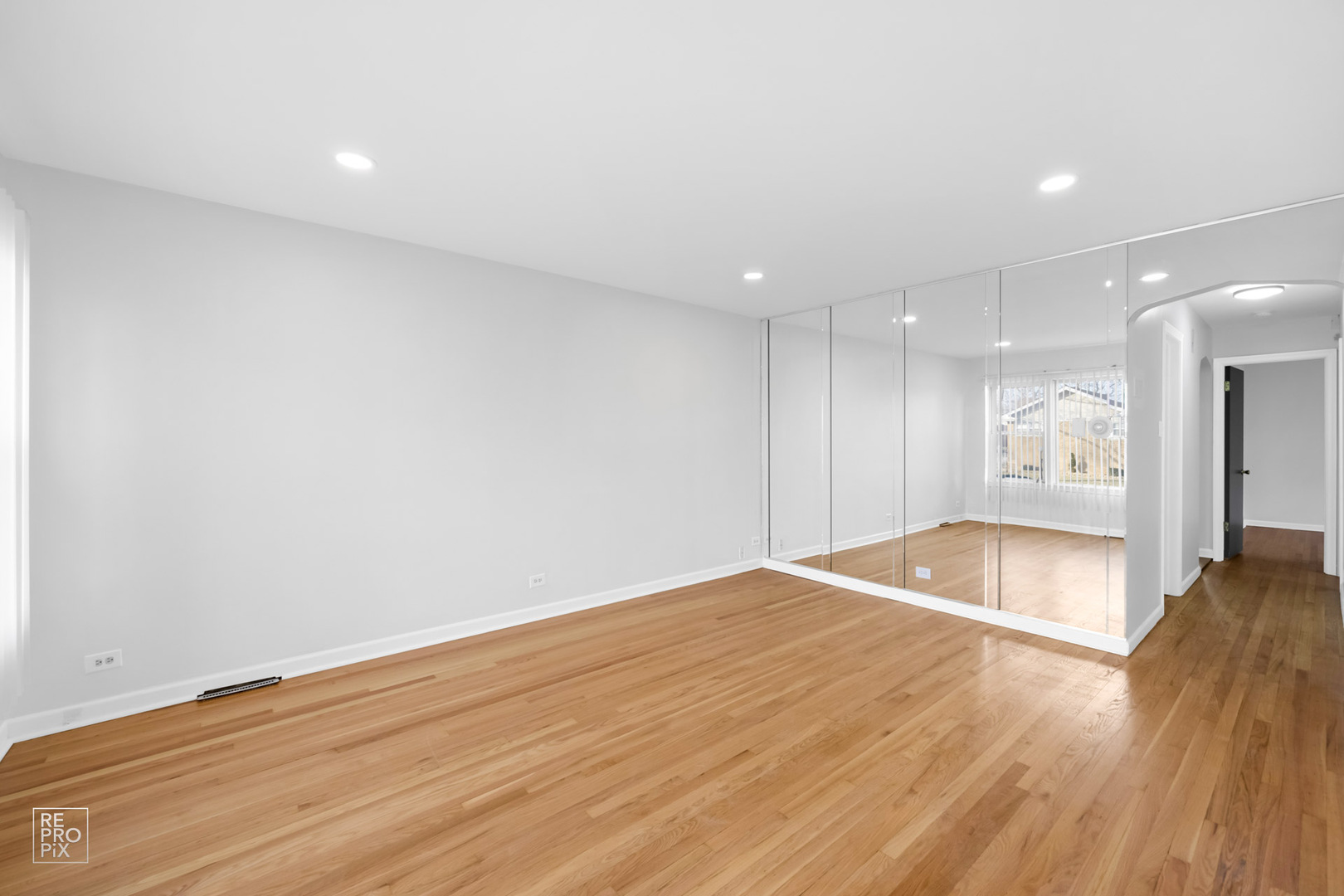 12552 South Harvard Avenue Chicago, IL 60628 - Photo 3 of 9 a view of an empty room with wooden floor