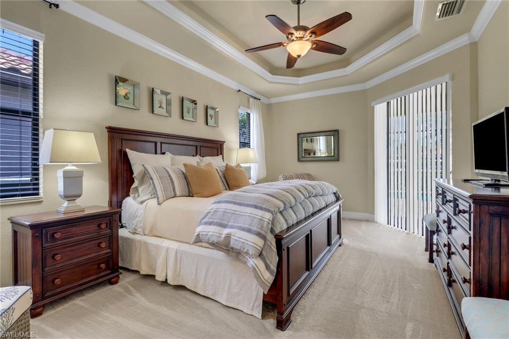 9434 Piacere Way Naples, FL 34113 - Photo 15 of 32 Bedroom featuring ornamental molding, light carpet, access to exterior, a raised ceiling, and ceiling fan
