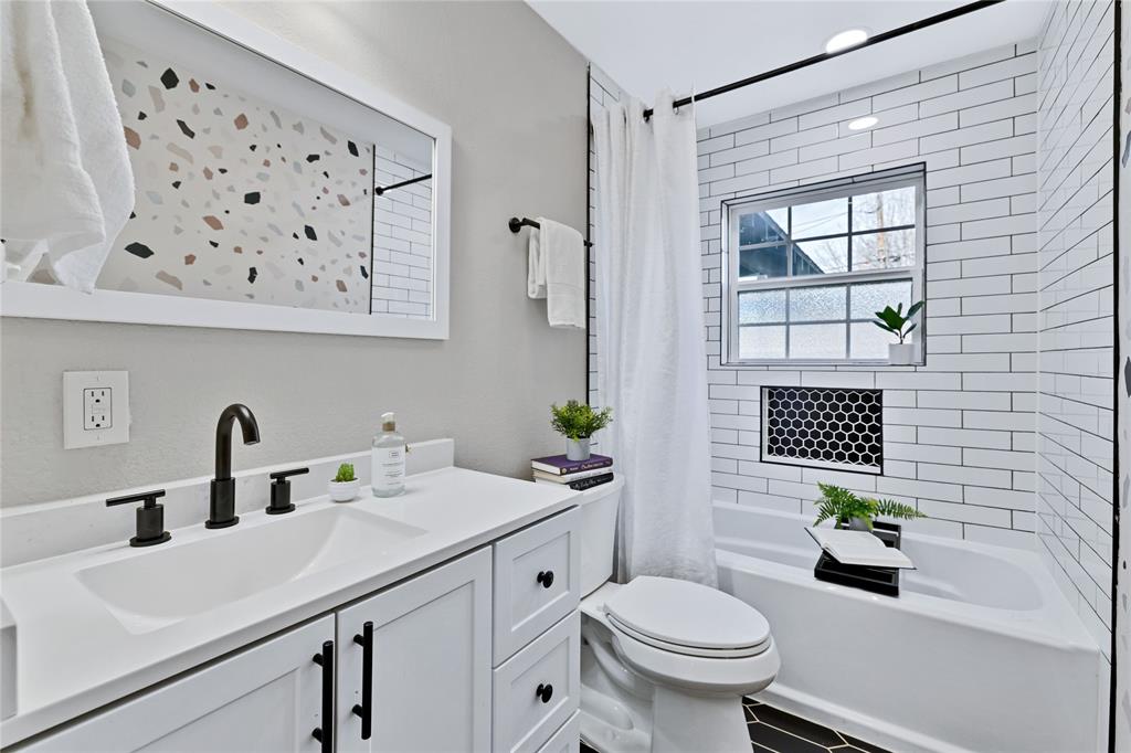 8635 Strathmore Drive Dallas, TX 75238 - Photo 15 of 35 a bathroom with a sink a toilet and shower