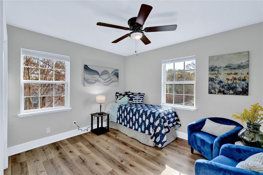 8635 Strathmore Drive Dallas, TX 75238 - Photo 19 of 35 a living room with furniture a bed and a window