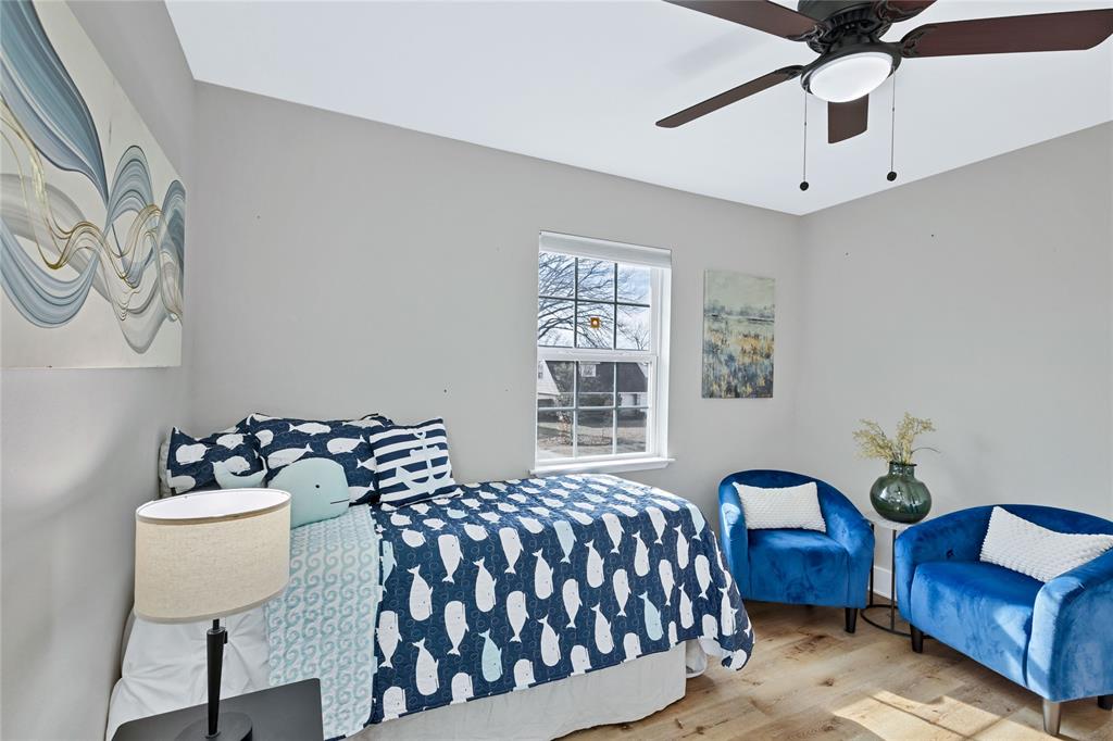 8635 Strathmore Drive Dallas, TX 75238 - Photo 20 of 35 a bedroom with furniture and a window