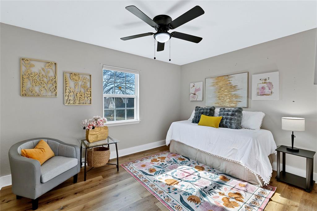 8635 Strathmore Drive Dallas, TX 75238 - Photo 21 of 35 a bedroom with furniture and a window