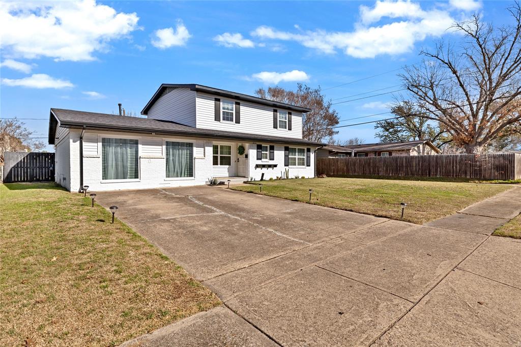 8635 Strathmore Drive Dallas, TX 75238 - Photo 35 of 35 a front view of a house with a yard