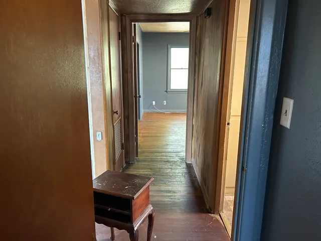 a view of a room with wooden floor and fan