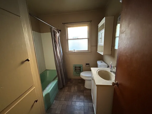 a bathroom with a sink a toilet and a mirror