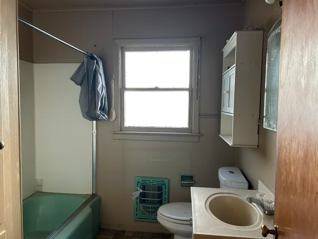 a view of a room with wooden floor and windows