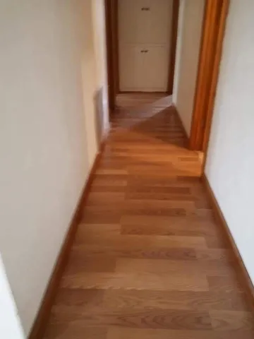 a view of a livingroom with a ceiling fan and window