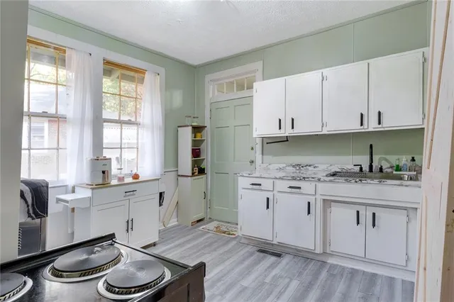 a kitchen with a sink stove and cabinets