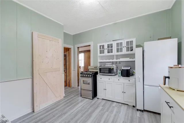 a kitchen with stainless steel appliances a stove a refrigerator and cabinets