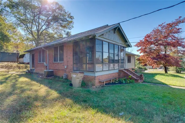 a view of backyard with table and chairs and a fence