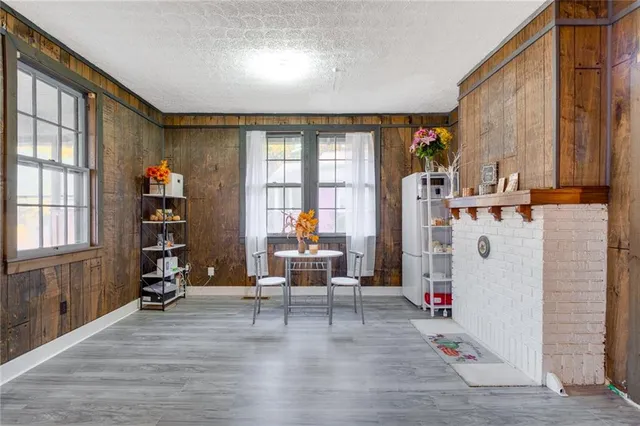 a living room with furniture a window and gym equipment