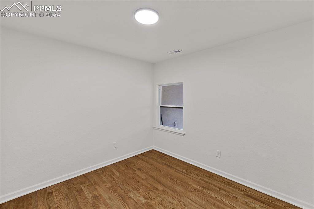 2615 East Boulder Street Colorado Springs, CO 80909 - Photo 17 of 50 a view of empty room with wooden floor and fan