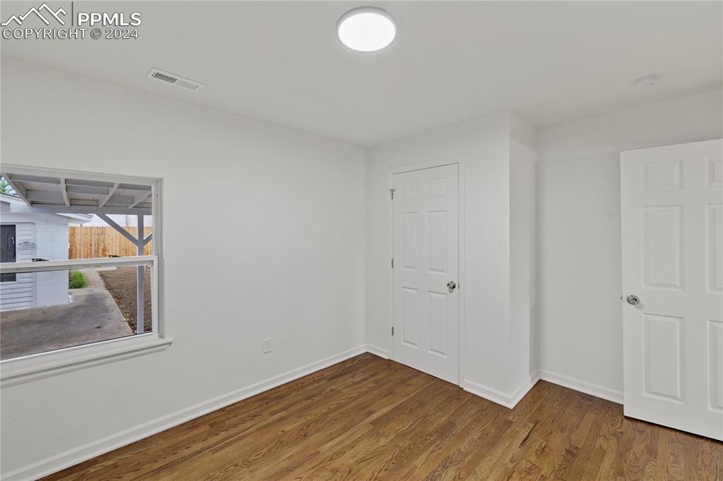 2615 East Boulder Street Colorado Springs, CO 80909 - Photo 18 of 50 a view of room with wooden floor and fan