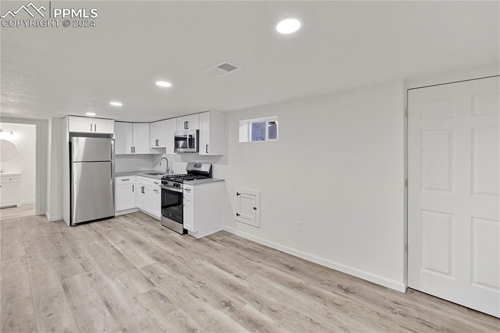 2615 East Boulder Street Colorado Springs, CO 80909 - Photo 20 of 50 a kitchen with stainless steel appliances a refrigerator and a stove top oven