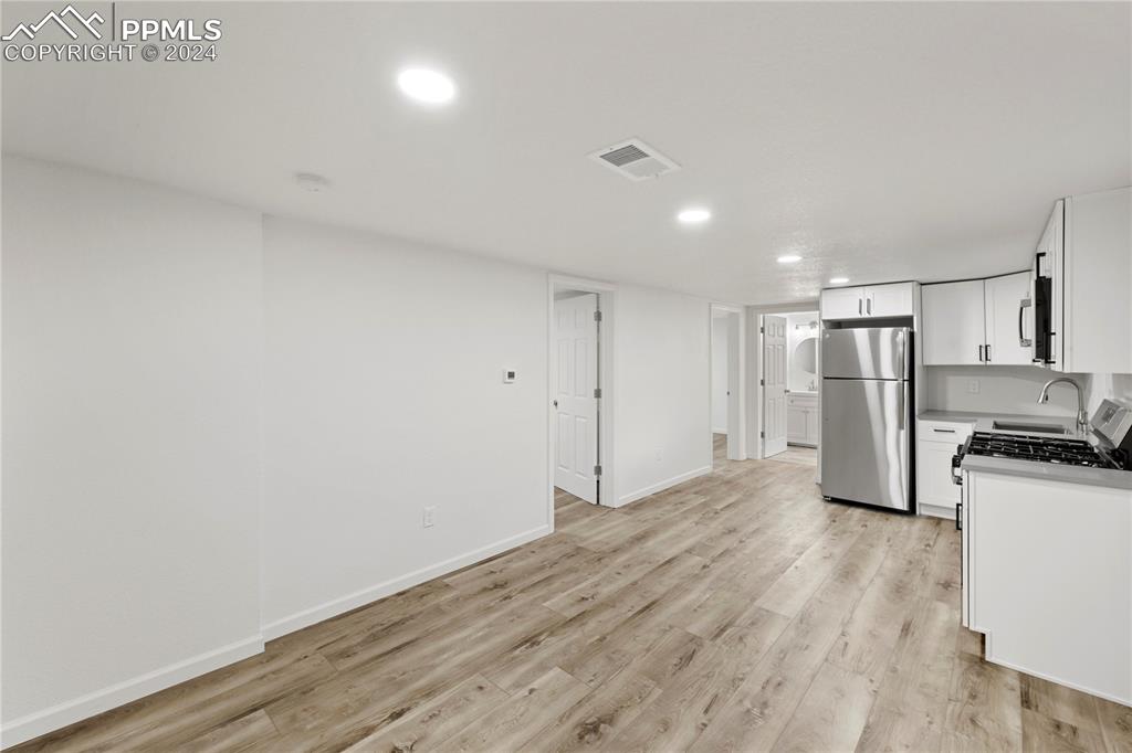 2615 East Boulder Street Colorado Springs, CO 80909 - Photo 25 of 50 a view of a kitchen with a sink and a refrigerator
