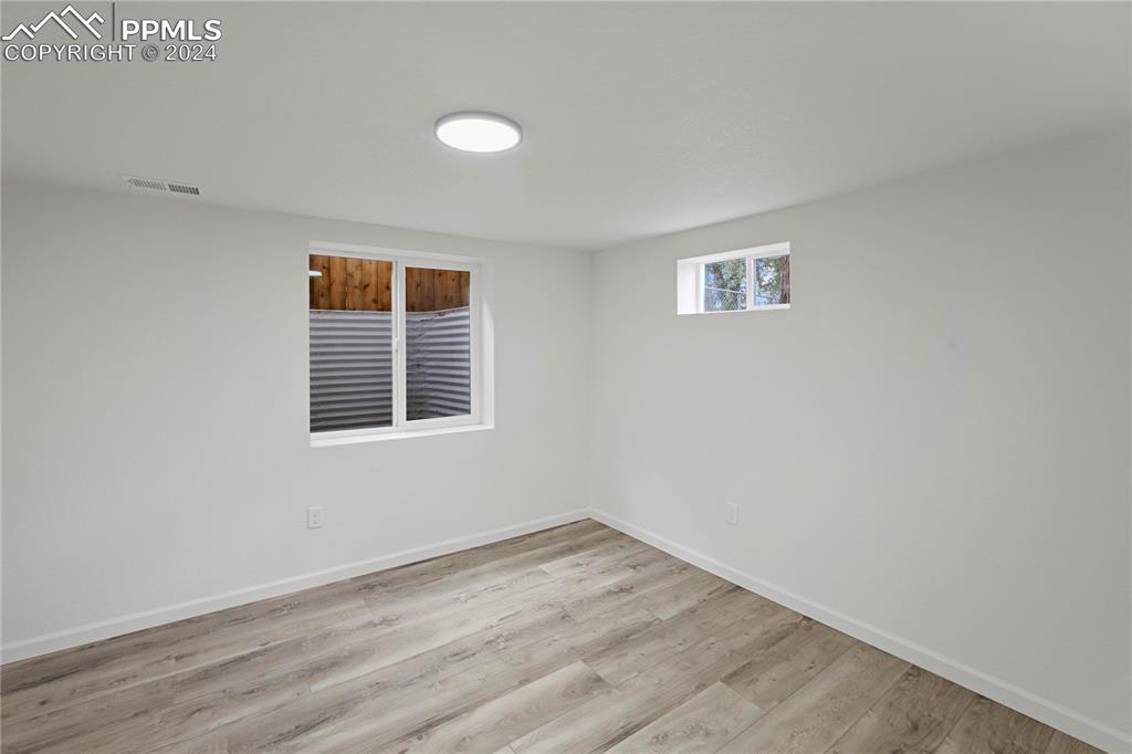 2615 East Boulder Street Colorado Springs, CO 80909 - Photo 28 of 50 a view of a room that has wooden floor and a window