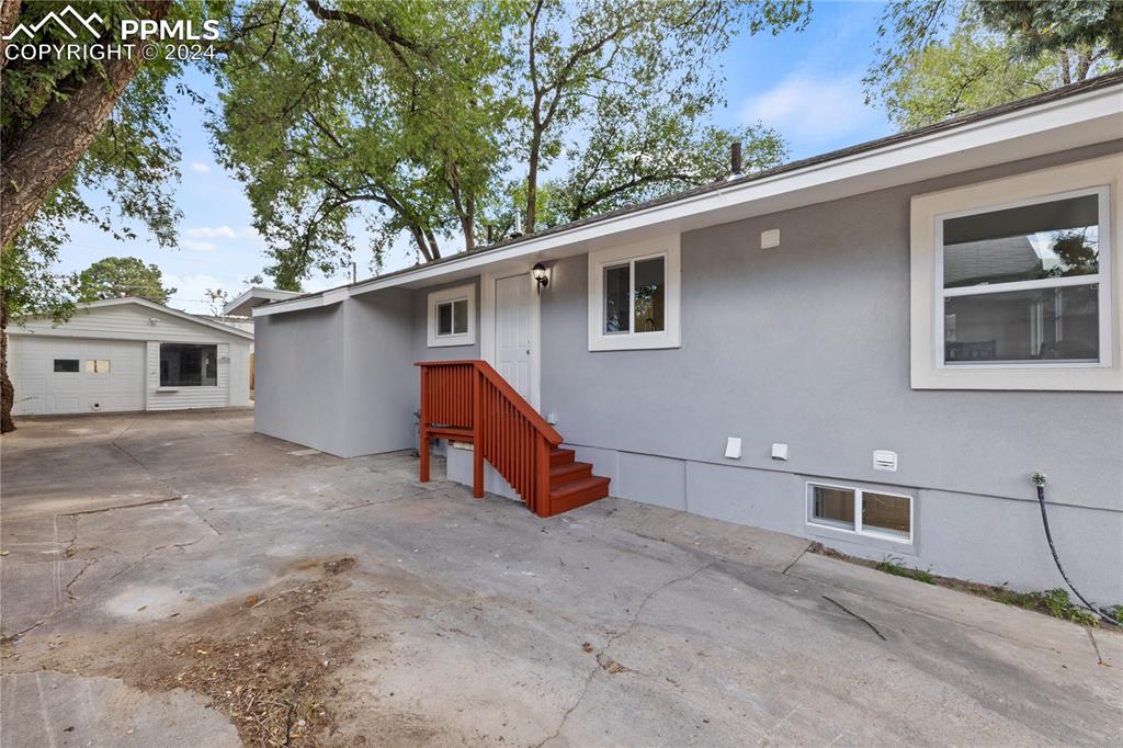 2615 East Boulder Street Colorado Springs, CO 80909 - Photo 40 of 50 a view of a house with a backyard and a tree
