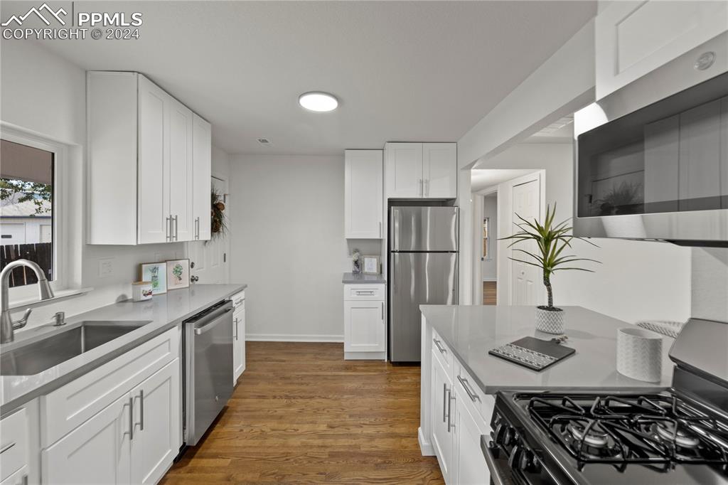 2615 East Boulder Street Colorado Springs, CO 80909 - Photo 8 of 50 a kitchen with stainless steel appliances a sink stove and refrigerator
