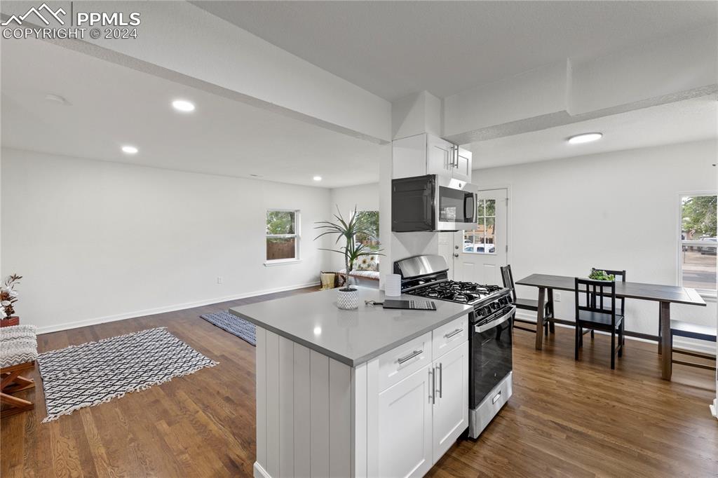2615 East Boulder Street Colorado Springs, CO 80909 - Photo 9 of 50 a kitchen that has a sink a stove and chairs