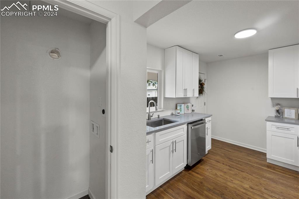 2615 East Boulder Street Colorado Springs, CO 80909 - Photo 10 of 50 a kitchen with a sink cabinets and wooden floor