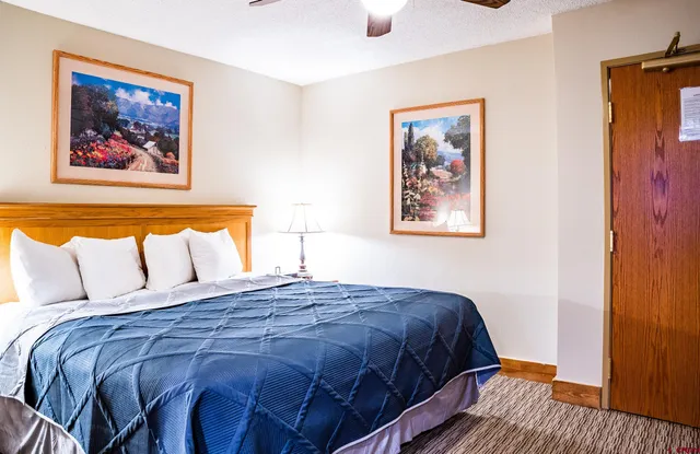 a bedroom with bed and wall painting