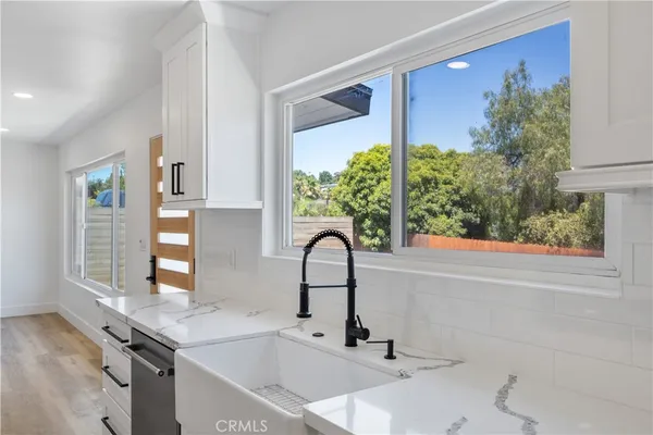 a kitchen with a sink and a large window