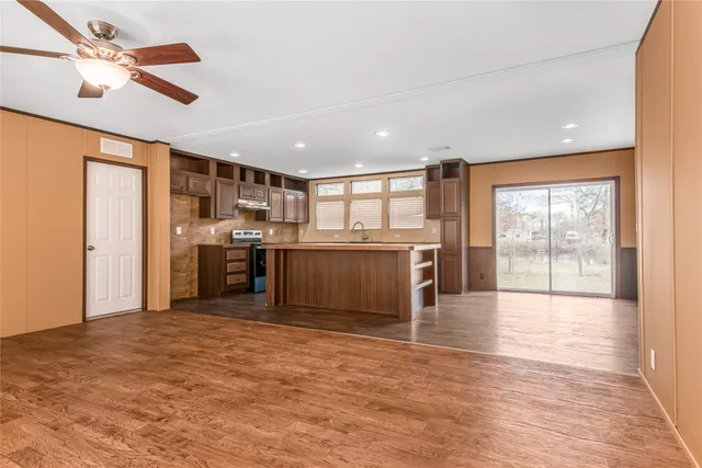 a view of a kitchen with a stove top oven and cabinets