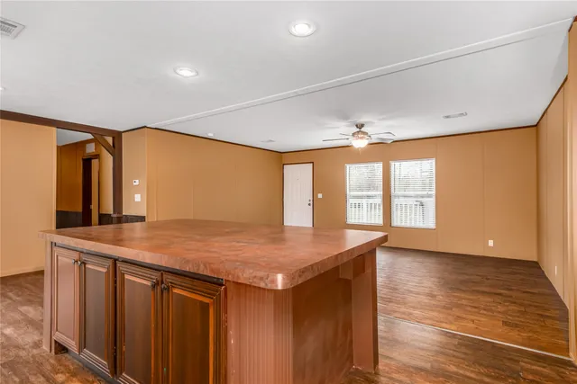 a kitchen that has a sink and a wooden floor