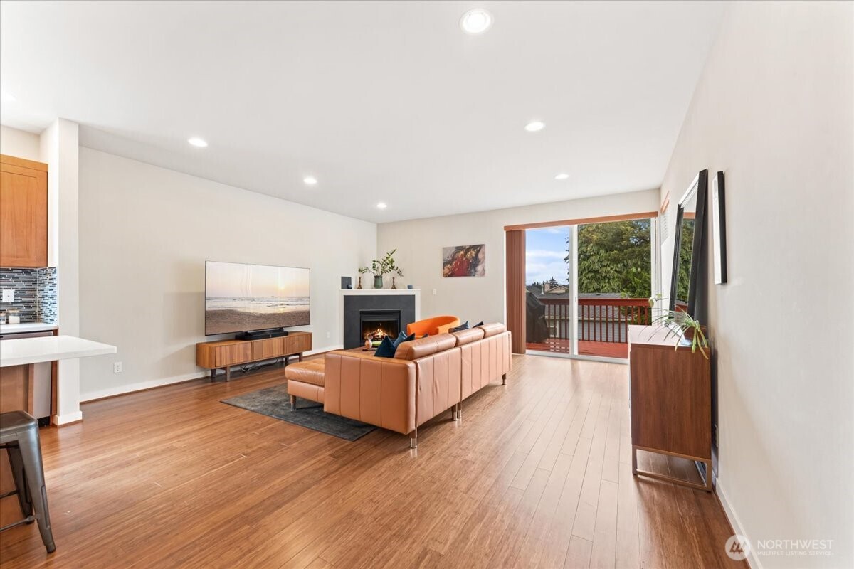 12418 2nd Place Southwest Burien, WA 98146 - Photo 3 of 39 a living room with furniture a flat screen tv and a floor to ceiling window