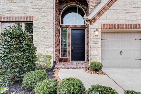 a kitchen with stainless steel appliances kitchen island granite countertop a sink and a stove top oven with wooden floor