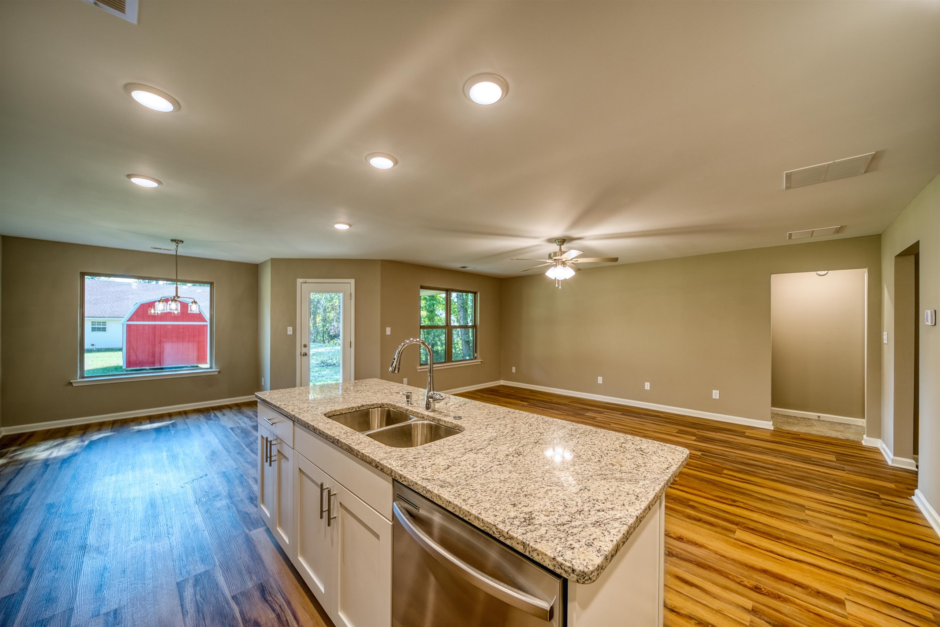 109 Walnut Ridge Ripley, TN 38063 - Photo 39 of 39 a kitchen with stainless steel appliances granite countertop a sink dishwasher and a stove with wooden floor