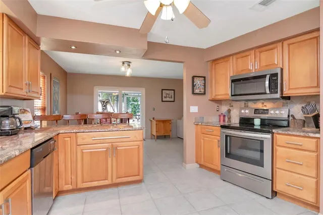 a bedroom with a large bed a flat tv screen and dresser