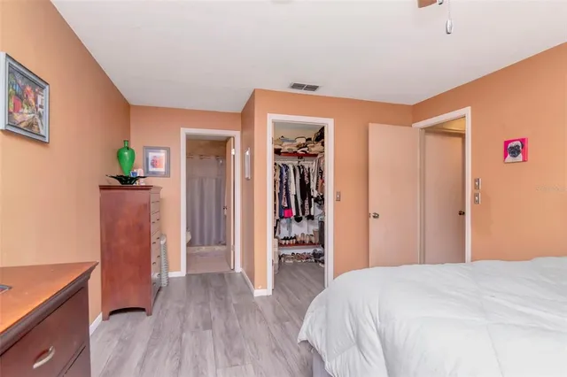 a bathroom with a sink a toilet a mirror and shower curtain