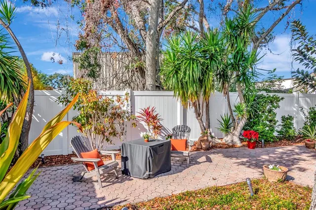 a view of a house with backyard and sitting area