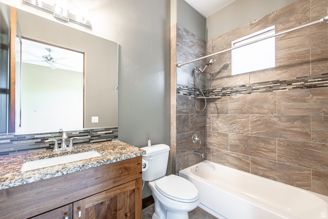 322 340 E Street Ivins, UT 84738 - Photo 37 of 61 Bathroom featuring a wood-finish vanity with an undermount sink and stone-look countertop
